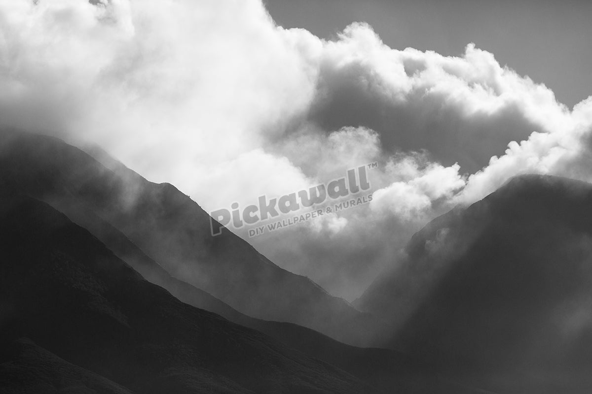Black and white image over scenic mountains.