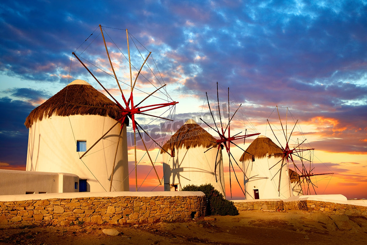 Sunset over the traditional Greek windmills of Mykonos Chora. Cyclades Islands, Greece