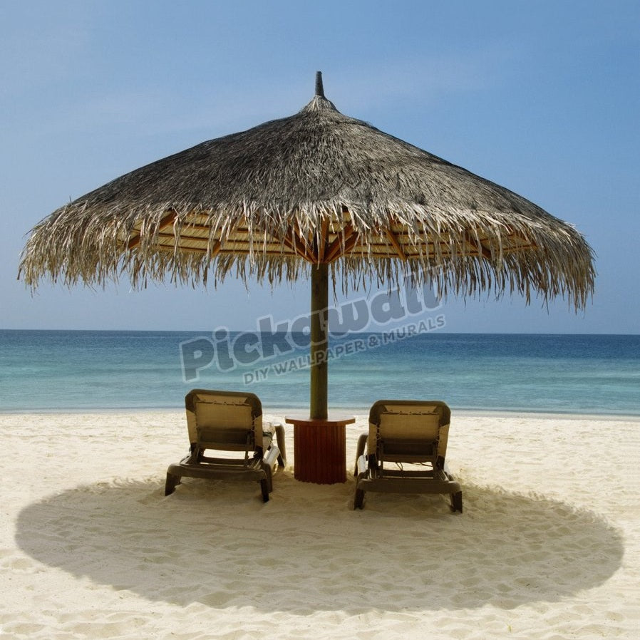 Beach chairs under a sun shade on a beach - Pickawall