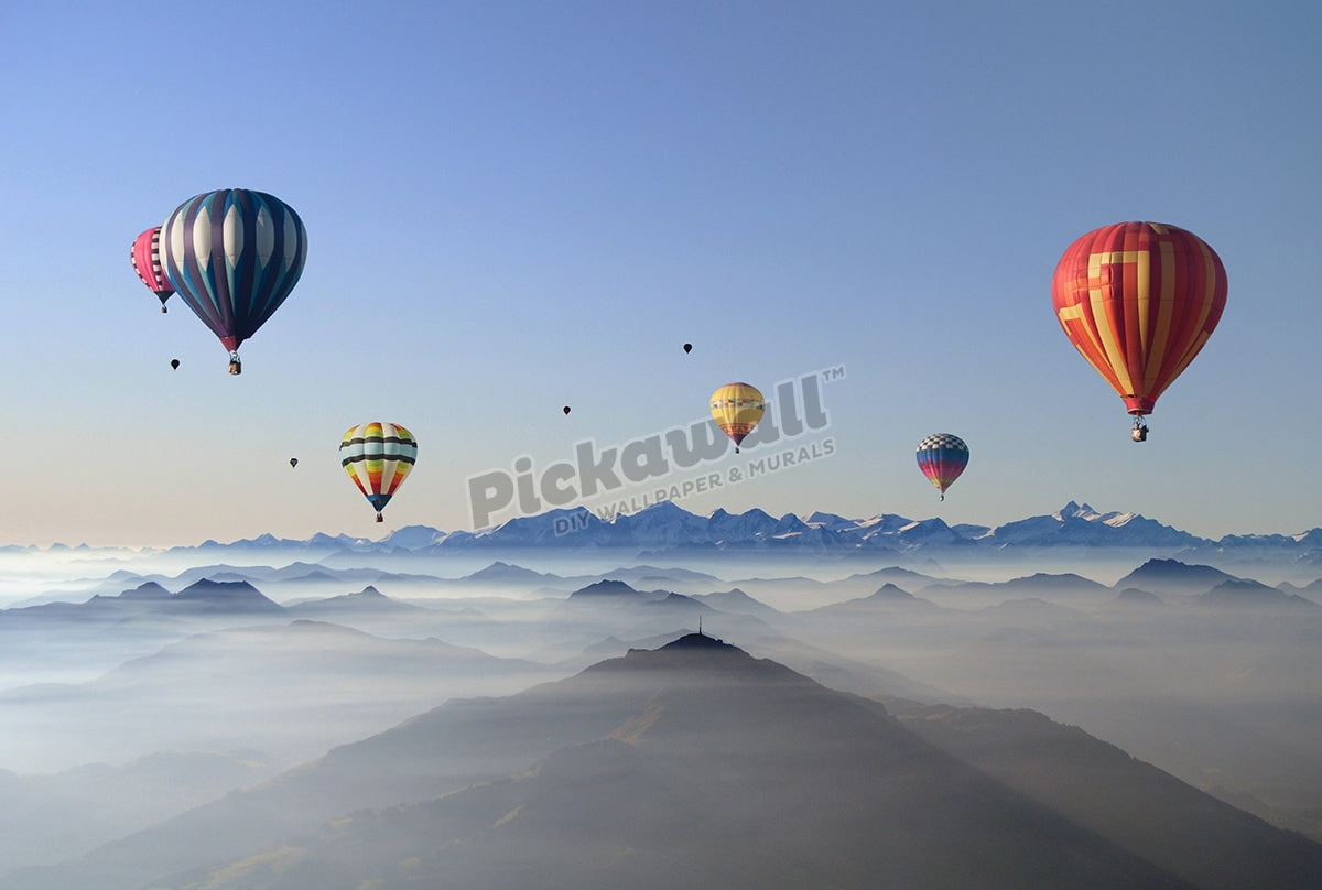 Hot air balloons over mountain skyline