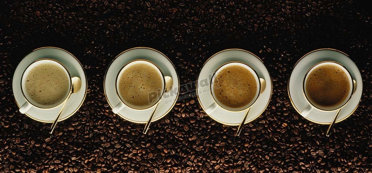 Four cups of cappuccino resting on coffee beans, overhead view - Pickawall