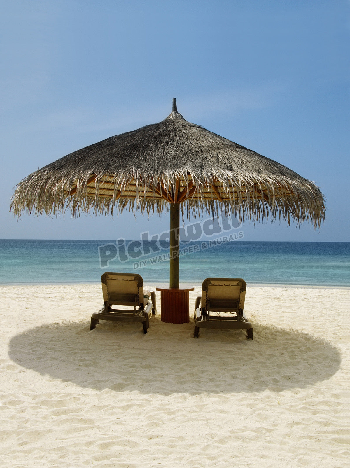 Beach chairs under a sun shade on a beach