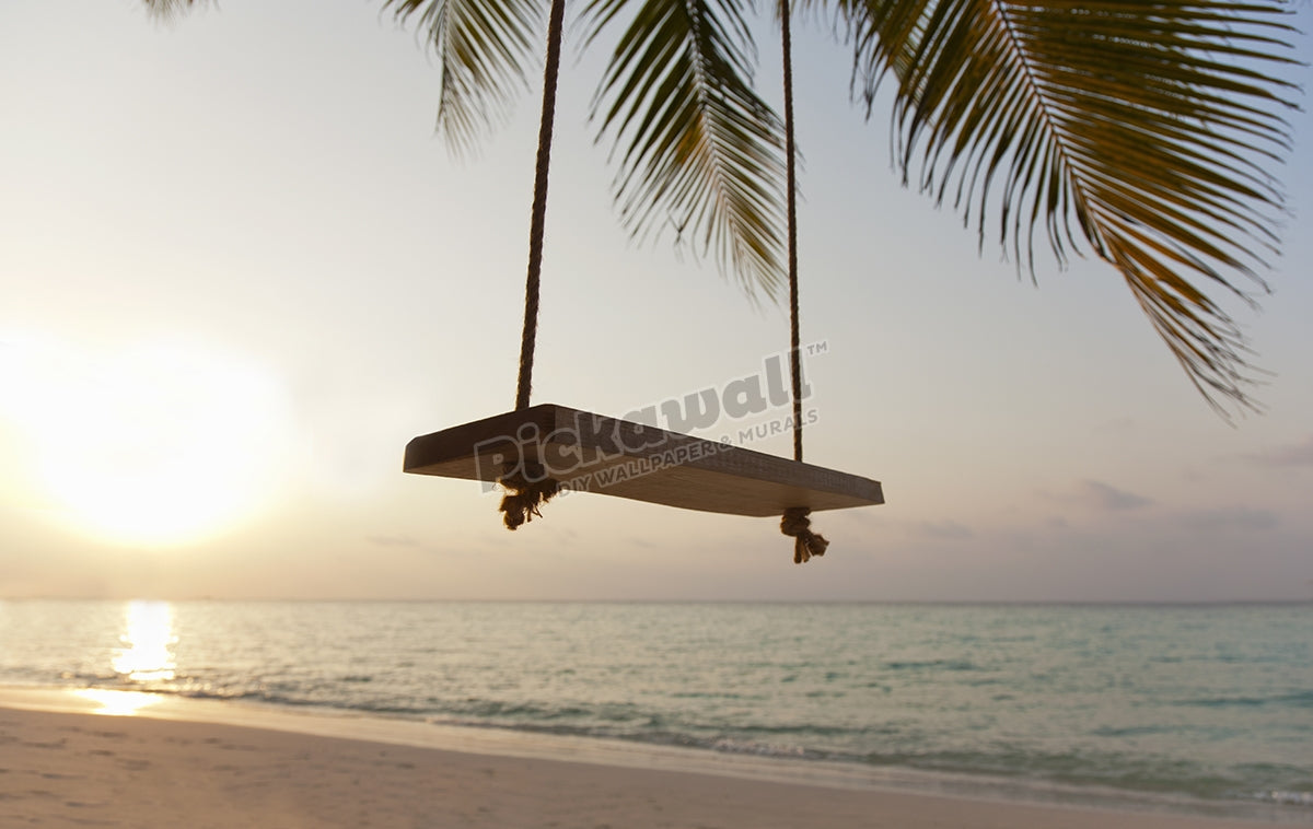 Swing on a beach at sunset