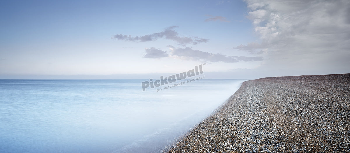 Calm blue sea and pebble beach