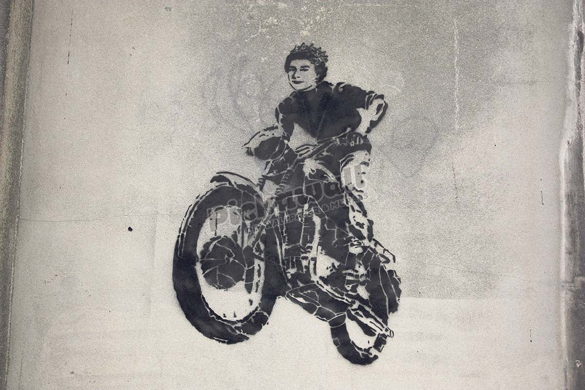 Banksy street art graffiti showing Queen on motorcycle