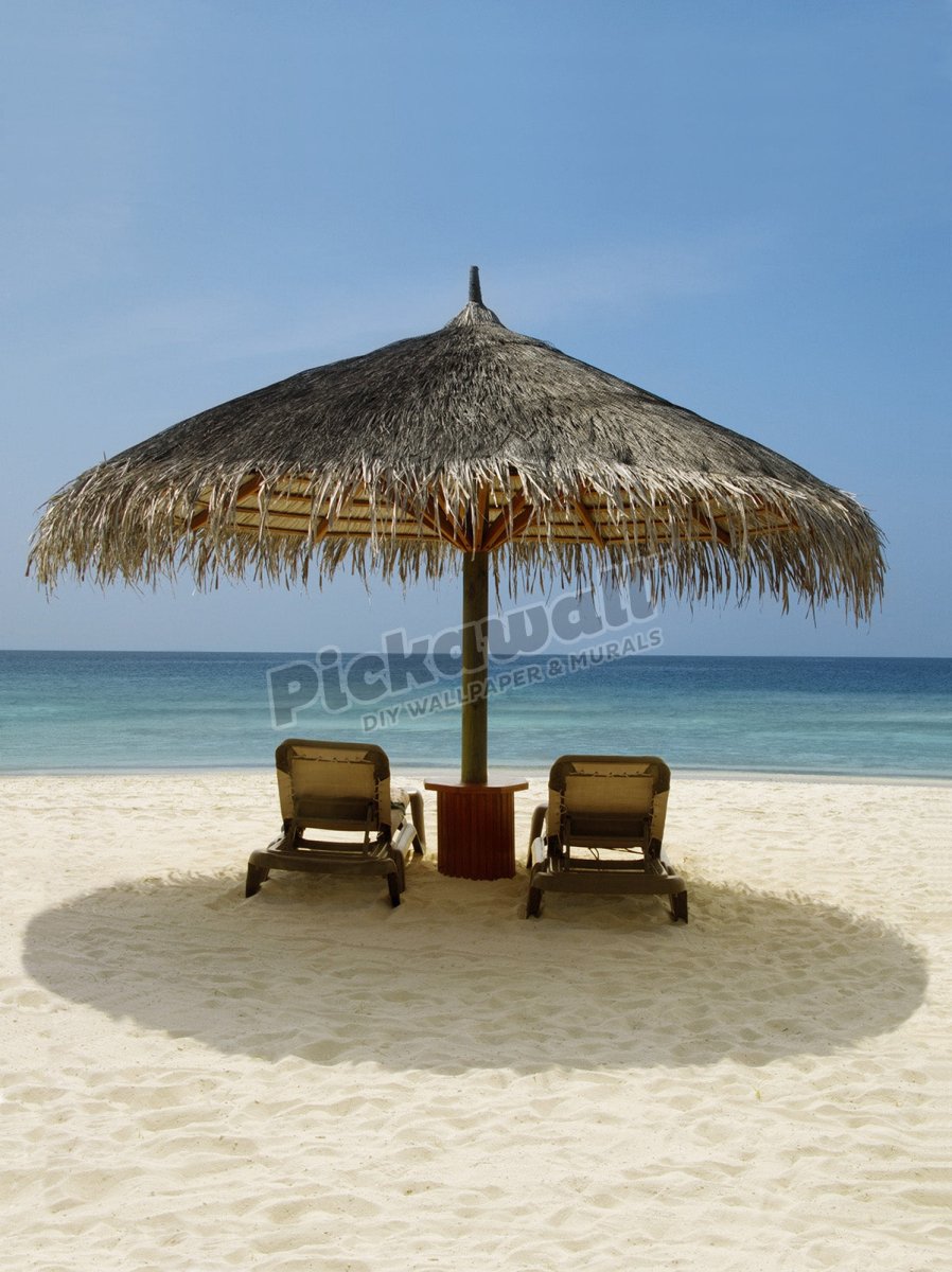 Beach chairs under a sun shade on a beach - Pickawall