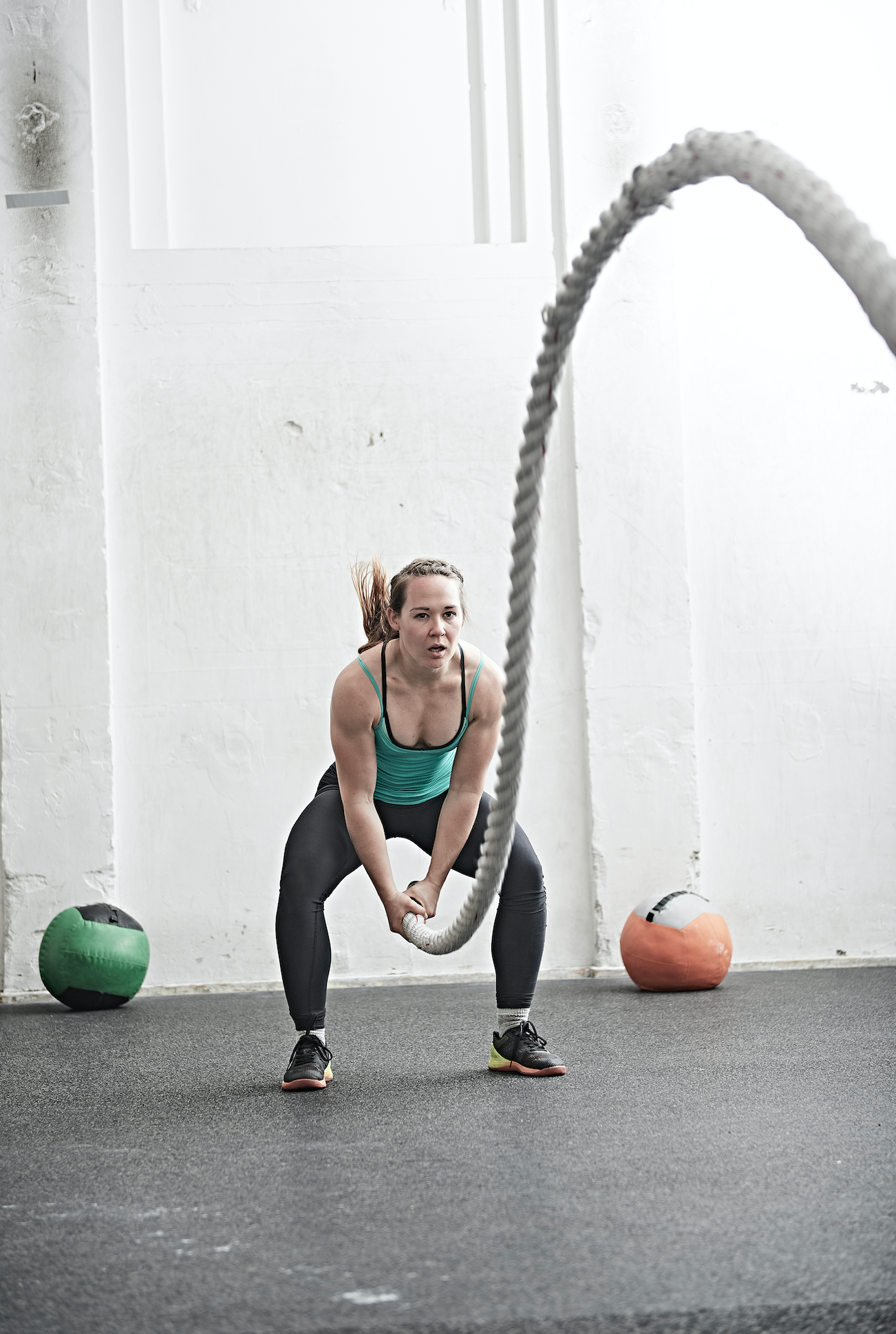 Woman working out with battle rope