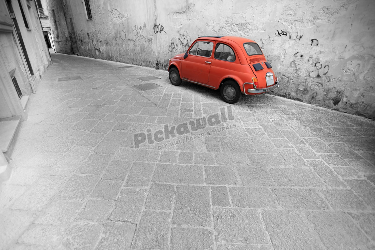 Tiny red vintage car in an Italian alley