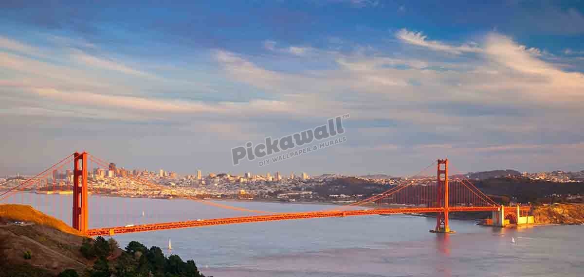 Last rays of setting sun shine on the Golden Gate Bridge, San Francisco, California USA - Pickawall