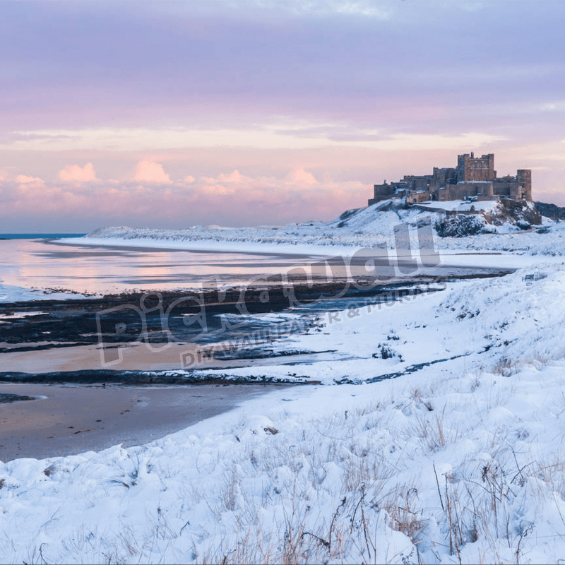 Snow covered winter scene at sunset, Bamburgh castle, YK - Pickawall